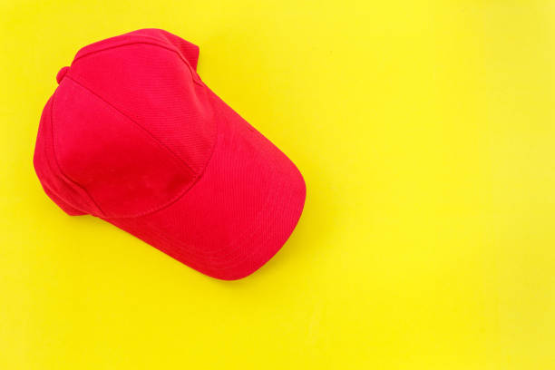 istock New blank red baseball hat on yellow background with free space for design 686226076