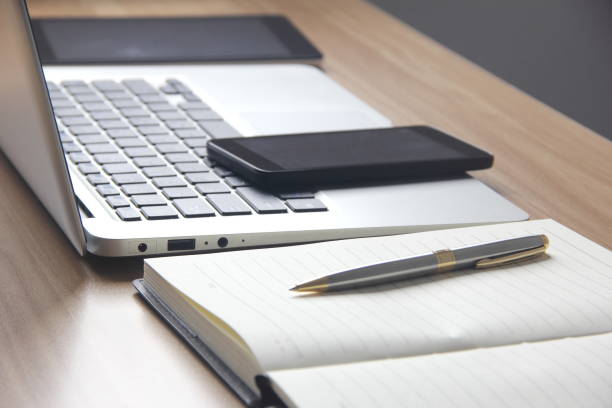istock Laptop, tablet, notebook and phone on the desk 686228448