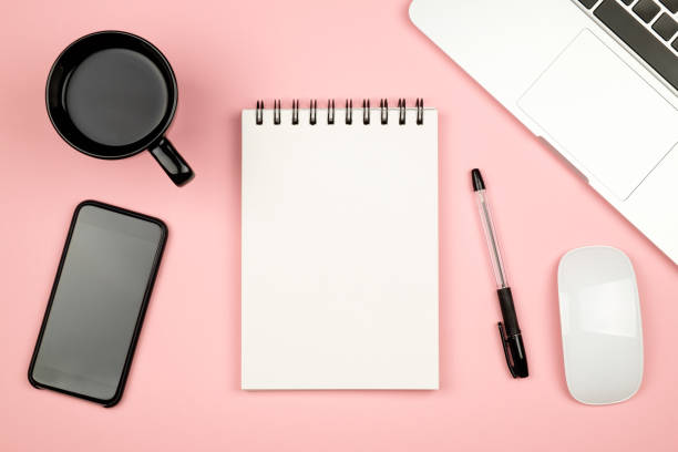 istock Modern office desk table with laptop, blank notebook page for input the text in the middle and other supplies. Top view, flat lay 686233882
