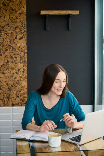 istock Young woman freelance working while being at the cafe 686235230