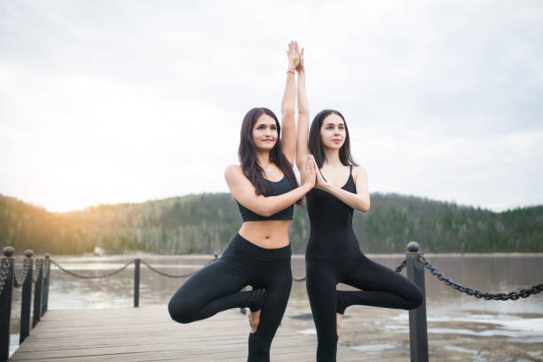istock Group of young people doing yoga in the class 686242028