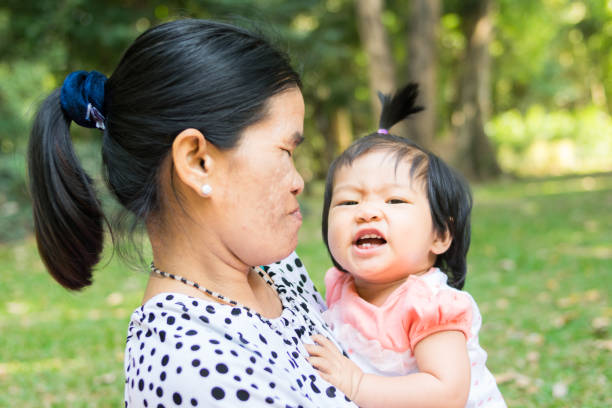 istock happy baby and mom on green park 686247852