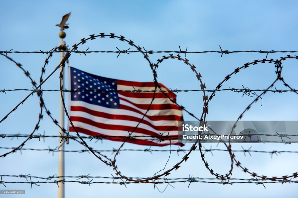 American flag and barbed wire, USA border Refugee Stock Photo