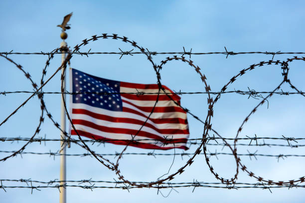 American flag and barbed wire, USA border American flag and barbed wire, USA border department of homeland security stock pictures, royalty-free photos & images