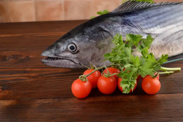 Photo of Shredded tuna with parsley and cherry tomatoes on the table