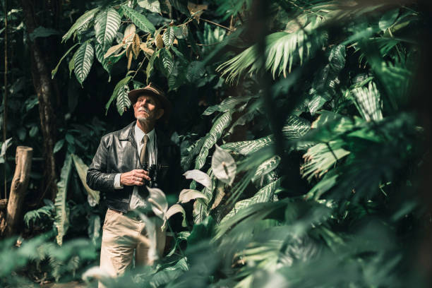 istock Alert explorer standing in jungle looking around. 686254328
