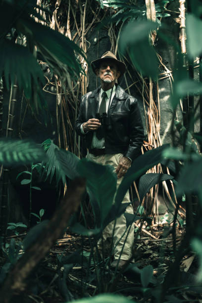 istock Senior explorer standing in dense jungle looking carefully. 686254346