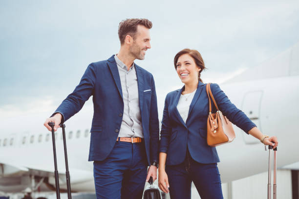 istock Business colleagues standing in front of airplane 686260424