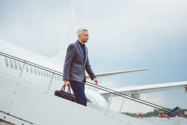 istock Mature businessman getting out of airplane 686260578