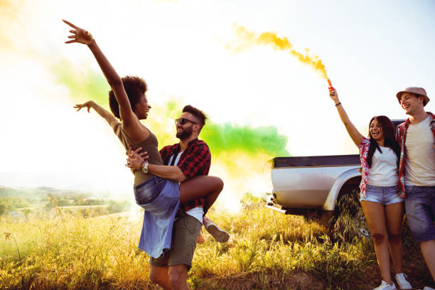 istock Friends holding smoke bombs having fun in a field 686261002