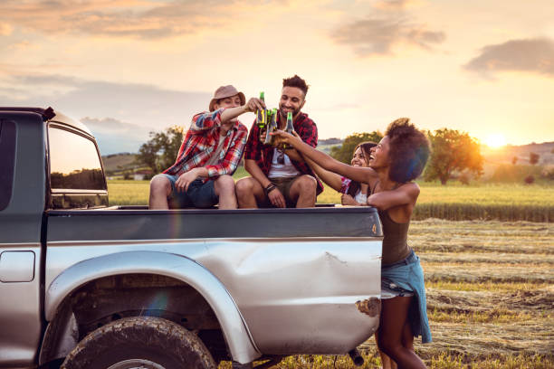 istock Road trip break at sunset drinking a fresh beer with friends 686261256