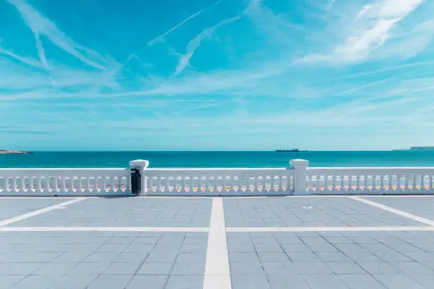 Beautiful promenade with white fence by the sea