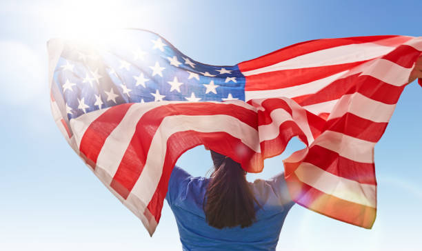 istock woman with American flag 686264340