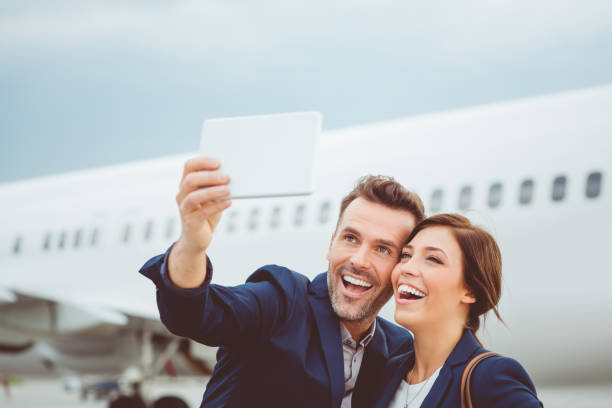 istock Couple talking selfie in front of airplane 686264636