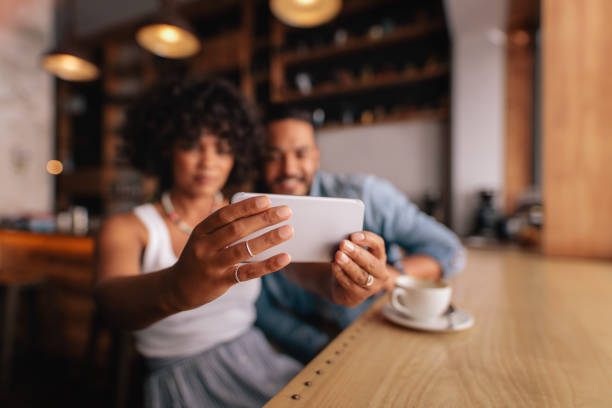 istock Couple taking selfie with smart phone at cafe 686270882