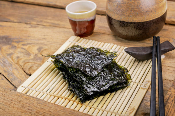 istock Nori sheets with sticks on the wood background 686273652
