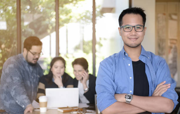 istock Young businessman smiling at camera in office 686274246