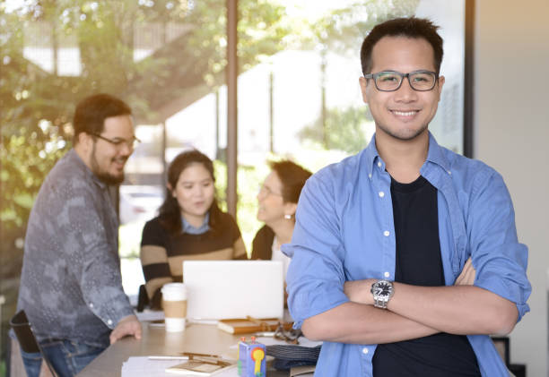 istock Young businessman smiling at camera in office 686274254