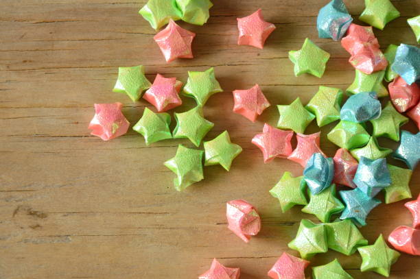 istock colorful star paper spreading on wooden board 686274828