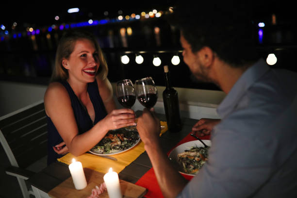 istock Young beautiful couple having romantic dinner on rooftop 686275640