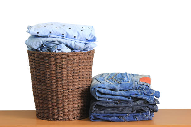 istock Clothes in a laundry wooden basket on wood table 686275646