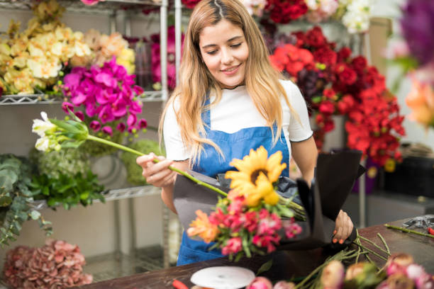 istock Cute florist wrapping a bouquet 686282064