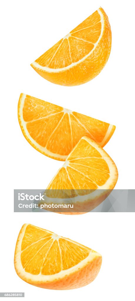 Isolated falling orange pieces Isolated orange wedges. Four falling pieces of orange fruit isolated on white background with clipping path Orange - Fruit Stock Photo