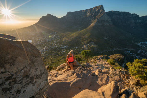 Young woman hiking in Cape Town at sunrise Young woman hiking in South Africa at sunrise, shot in Cape Town. People reaching their goals, achievement concept table mountain south africa stock pictures, royalty-free photos & images