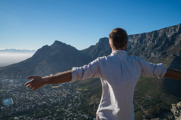 istock Freedom in nature, man arms outstretched at sunset 686289302