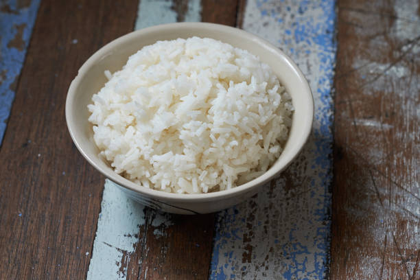 istock White rice bowl on wooden table. 686297832