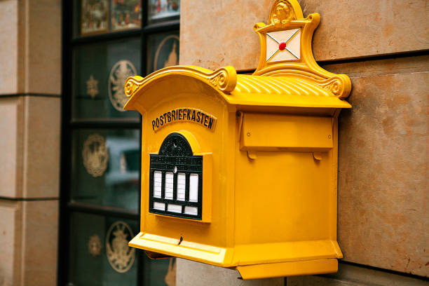 istock A traditional yellow letter box in Germany. Communication between people, sending letters and receiving messages. 686308104