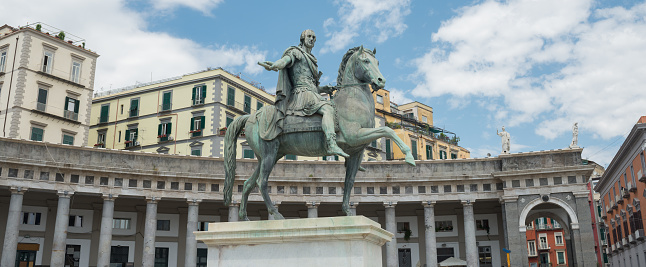 Rome, Italy: the pines of via dei Fori Imperiali and the statue of Cesare Nerva Augusto emperor in foreground.