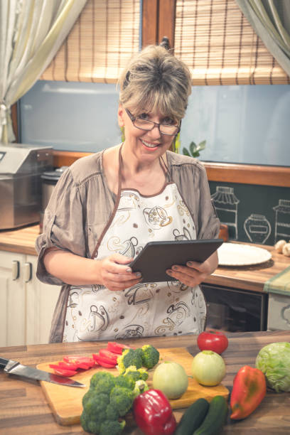 istock Female chef cooking writing blog on the internet. 686315802