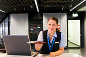 Airline Employee handing Ticket and Passport to Customer