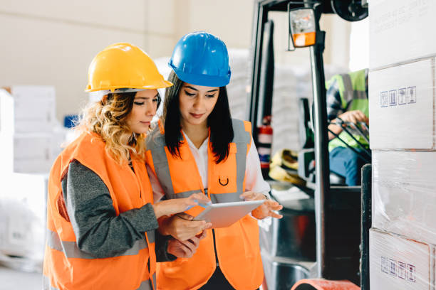 istock Female workers using a digital pc tablet in the factory warehouse 686321278
