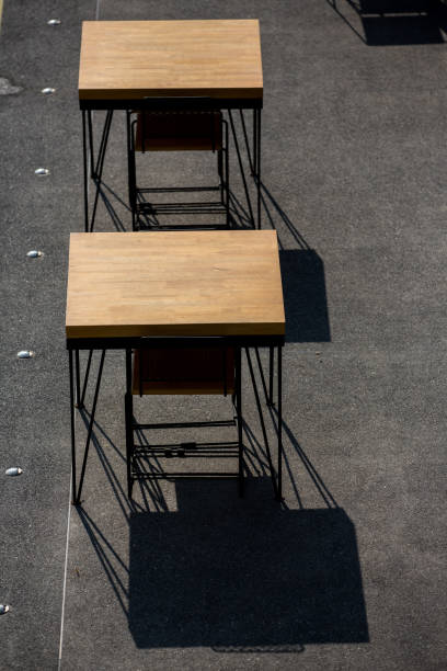 muebles de restaurante y vajilla en una zona al aire libre iluminada - outdoors store beach bench fotografías e imágenes de stock