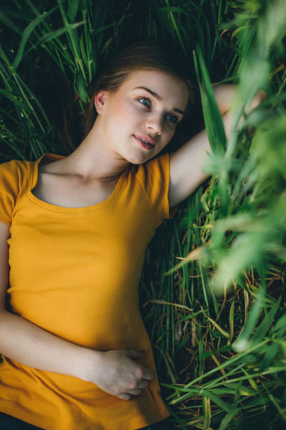 istock Smiling girl lying in wheat 686339006