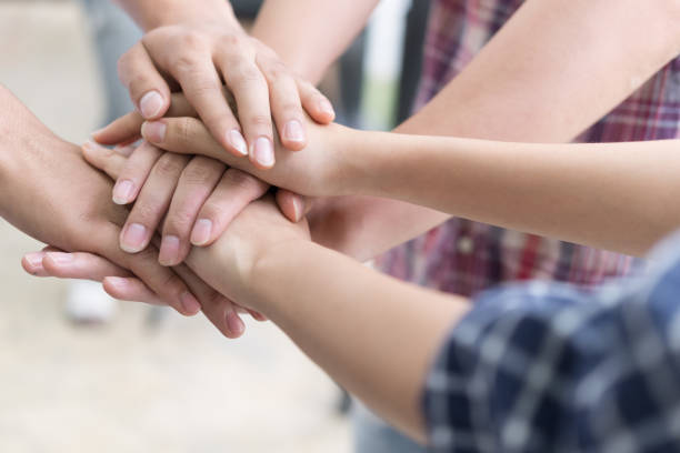 istock young college student joining hand, business team touching hands together - unity, harmony, teamwork, friends concept 686347502