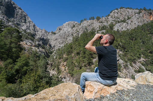 The Turkish man is looking at the mountains in the göğnük canyon in Antalya, Kemer.