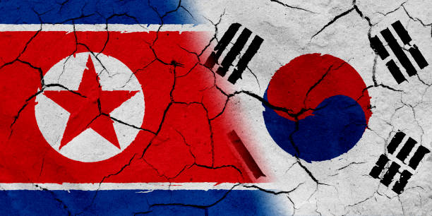 istock North Korea and South Korea flag together, with dried soil texture 686359682