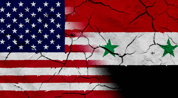 istock USA and Syria flag together, with dried soil texture 686359848