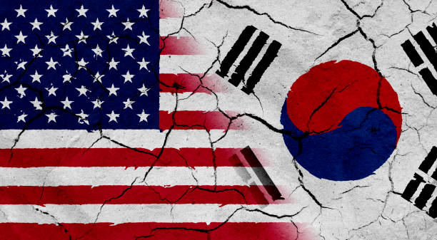 istock USA and South Korea flag together, with dried soil texture 686359856