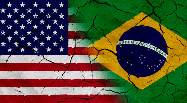 istock USA and Brazil flag together, with dried soil texture 686359998