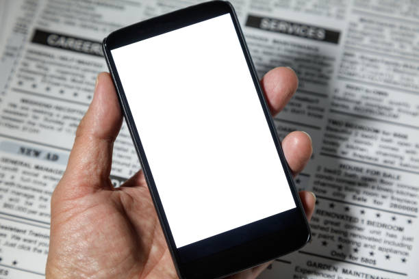 Fake newspaper and smartphone with blank screen. business communication concept.
