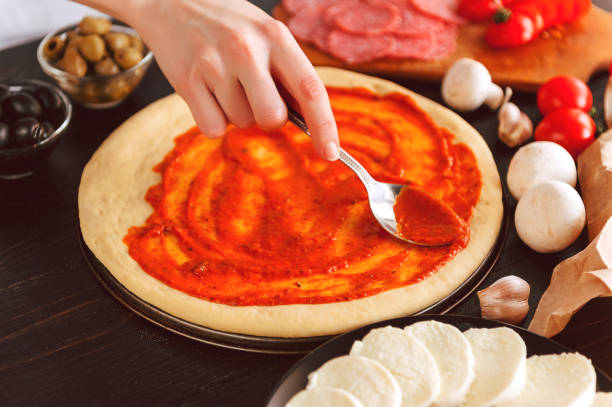 istock Raw pizza ingredients on wooden table 686360292