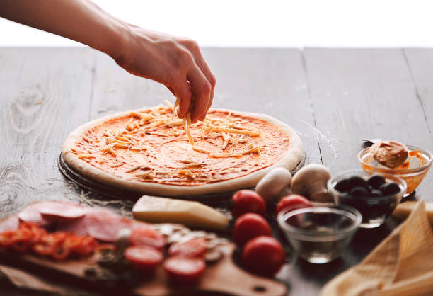 istock Raw pizza ingredients on wooden table 686360662