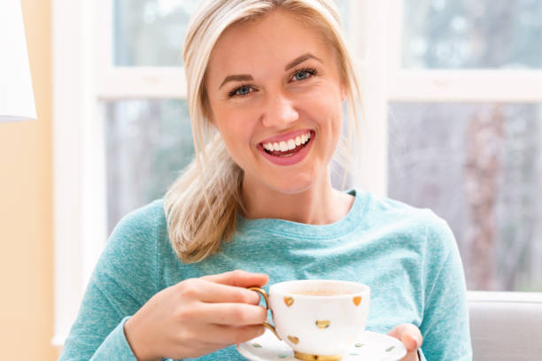istock Happy young woman drinking coffee 686360770