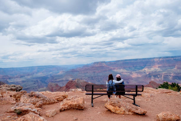 istock Two person sitting Grand Canyon view 686367110