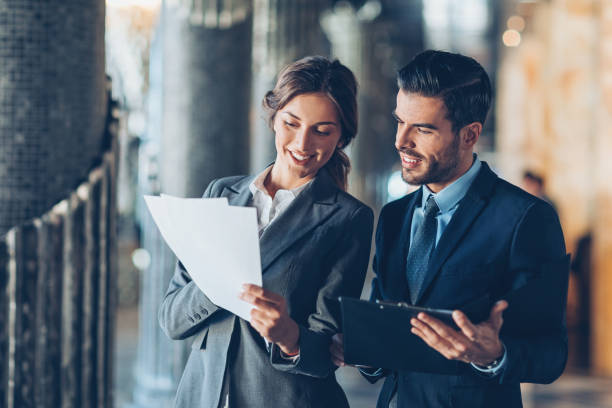 Teamed for success Smiling business persons looking at documents woman necktie stock pictures, royalty-free photos & images