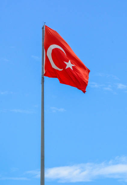 istock Turkish flag flying in bright blue sky in Bodrum, Turkey 686376888